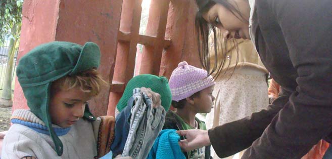 WINTER WARMTH: Nainika Singla, from KMC distributing woolen clothes to the kids at Eclair Delhi